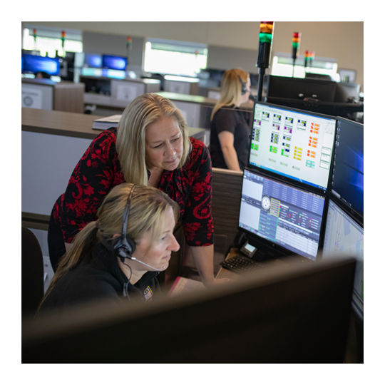 People looking at computer screens to monitor endpoint security and find solutions.