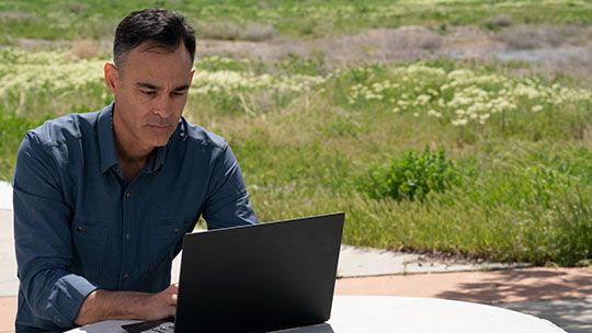 Man working on a laptop outside