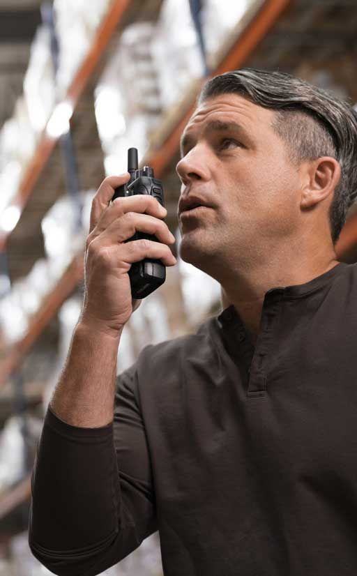 Man talking into a radio in a distribution center