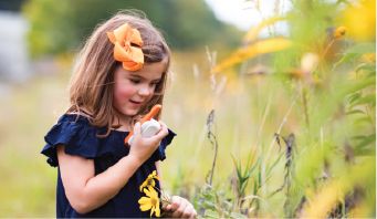 Young girl playing outside and using orange t110